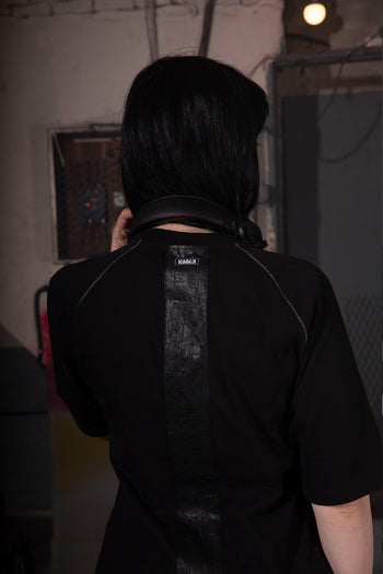 Close-up of KIMMICK Creviced Bite Raglan Black short sleeve top showing textured fabric and relaxed fit.