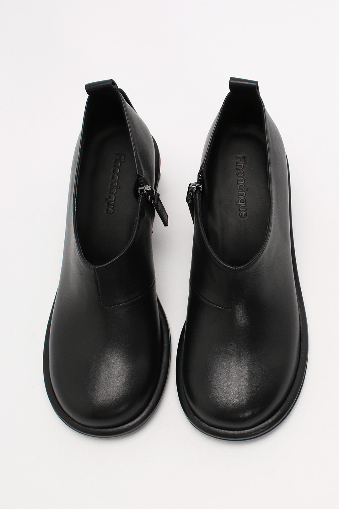 Black Moon Short Boots by Finoacinque featuring a sleek silhouette and stylish design, shown on a model.