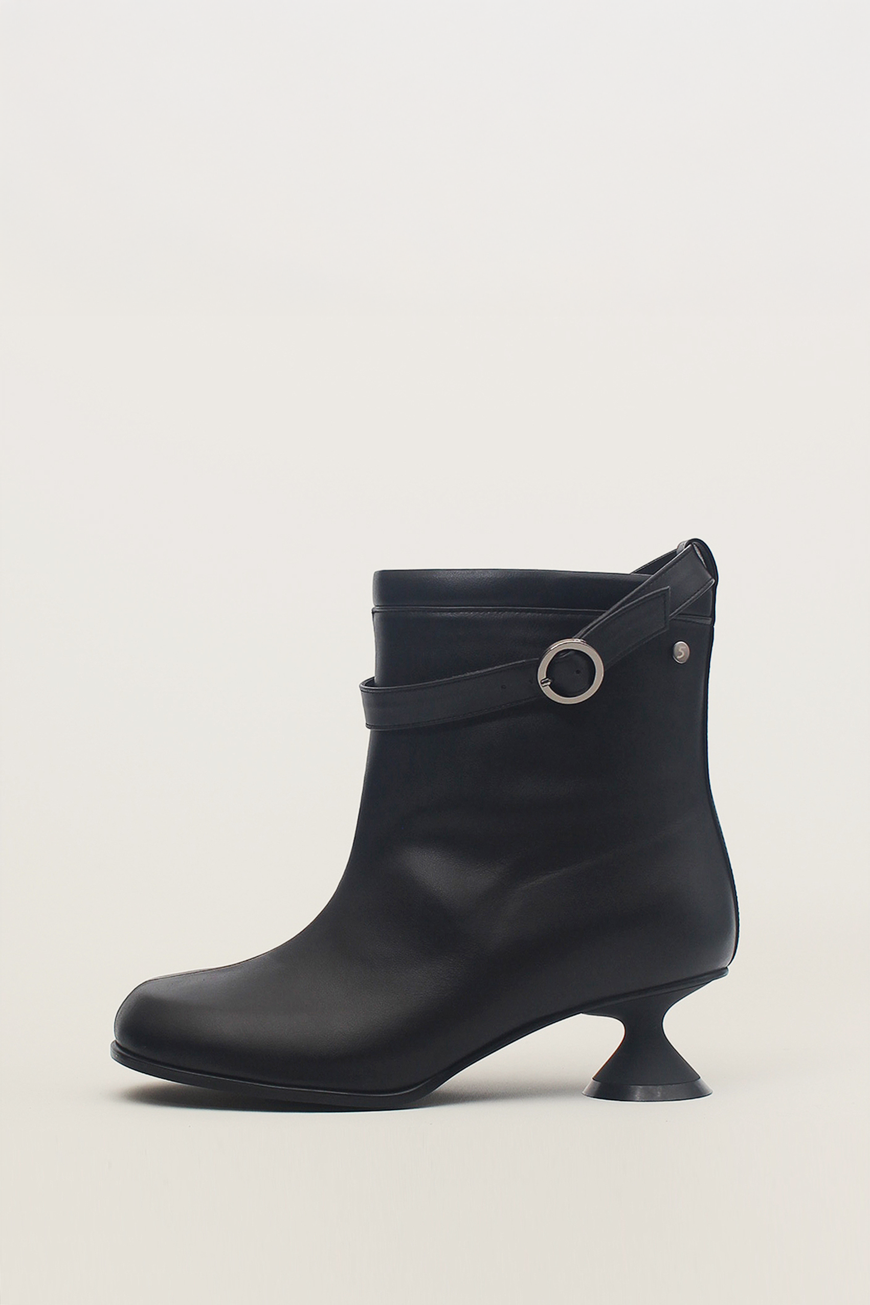 Black Uhjeo Hourglass Middle Heel Strap Boots by Finoacinque featuring ankle-high design and stylish strap details.