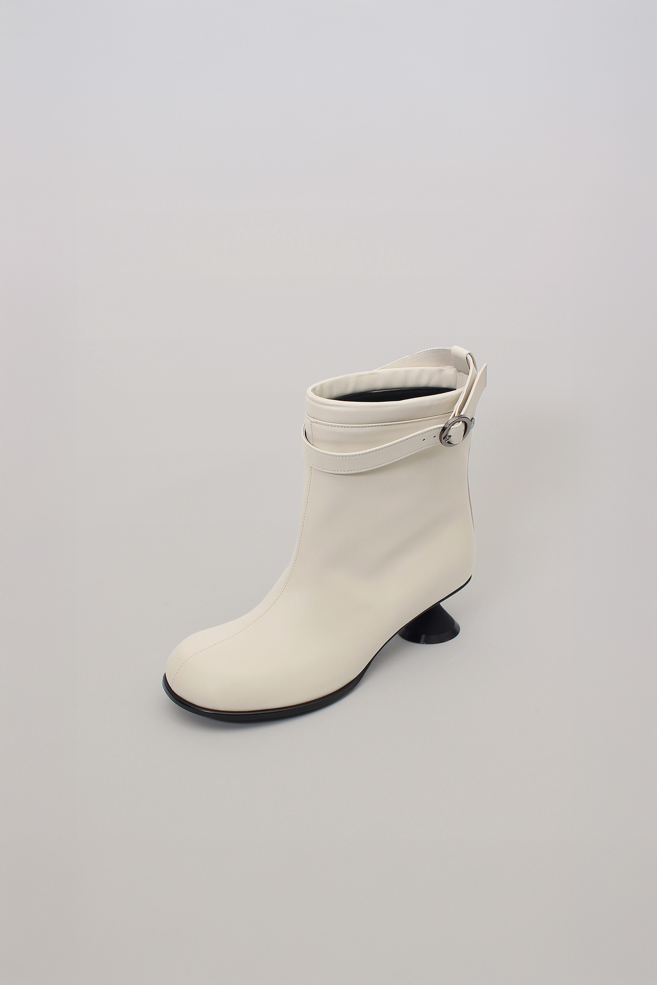 White Uhjeo Hourglass Middle Heel Strap Boots by Finoacinque with ankle straps and sleek design, shown from the side.