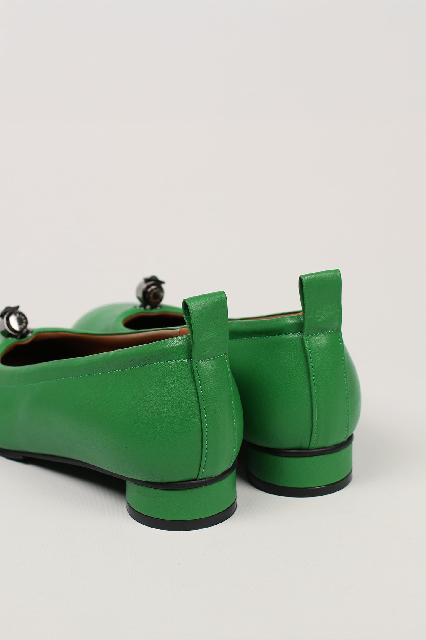 Green Ngela round toe stopper flat shoes by Finoacinque, featuring a sleek design and comfortable flat sole.