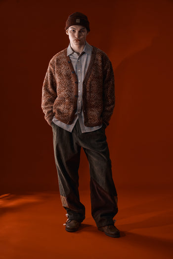 IOEDLE flowing landscape short beanie in red and brown, snug fit, soft knit fabric, featuring a colorful landscape pattern.