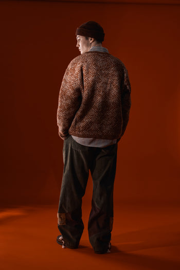 Red and brown flowing landscape short beanie by IOEDLE, shown on a model with a snug fit and soft knit texture.