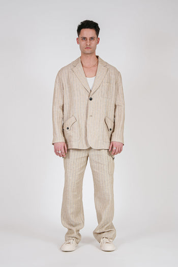 Beige linen cargo pants from IOEDLE featuring multiple pockets and a relaxed fit, shown on a model.