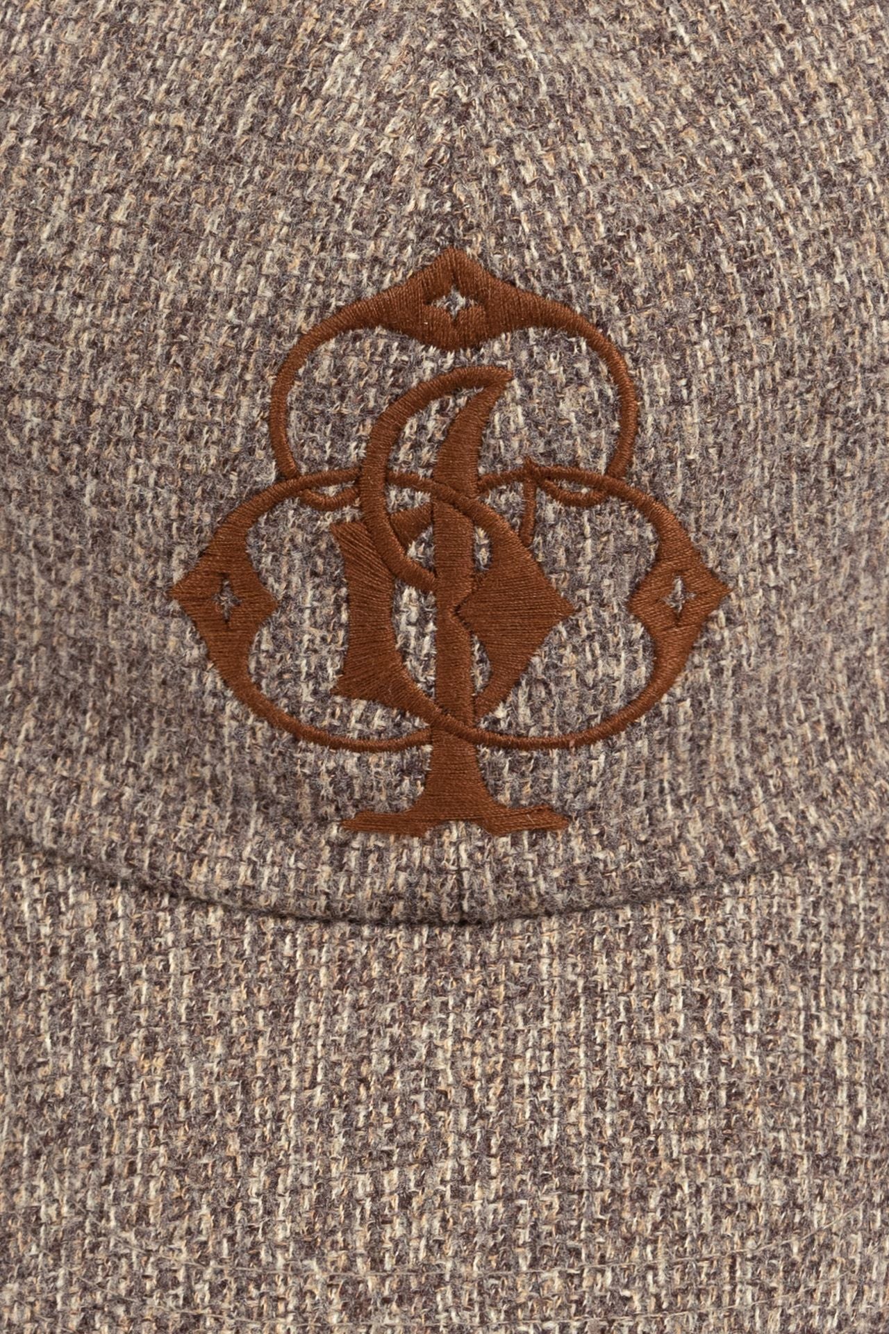 IOEDLE Clover Symbol Weaving Cap showing a casual cap with a prominent clover design on the front.