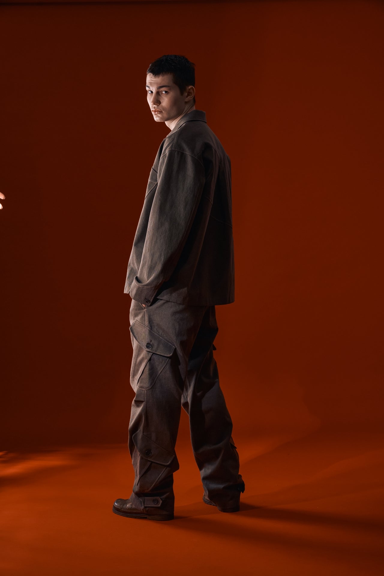 Brown Dirt Cargo Pants by IOEDLE, shown with rugged cargo pockets and durable fabric, ideal for outdoor and casual wear.