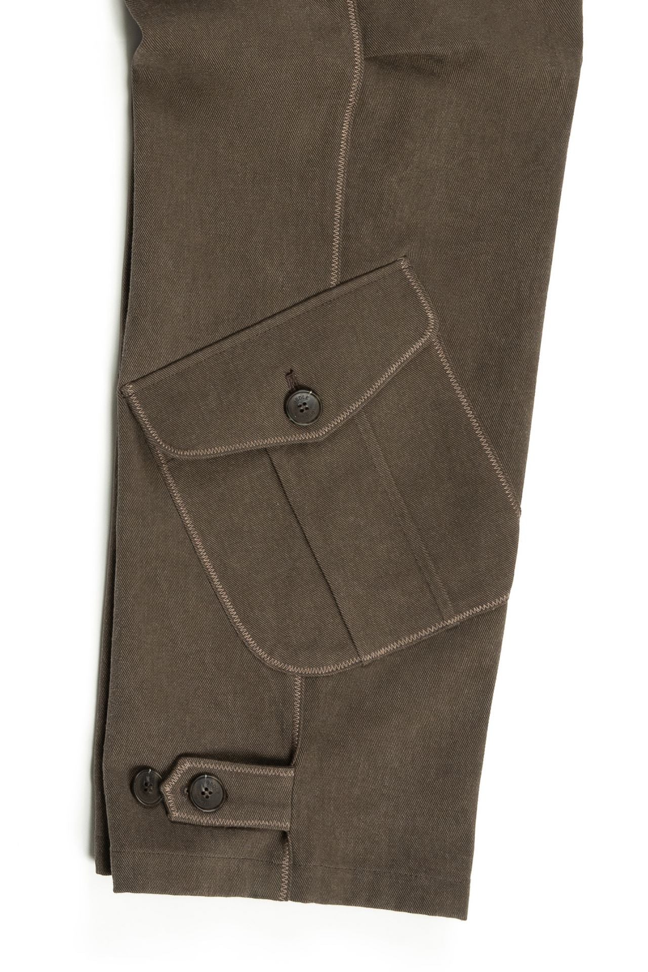 Brown dirt cargo pants from IOEDLE, styled with jacket fabric, featuring multiple pockets and rugged design.