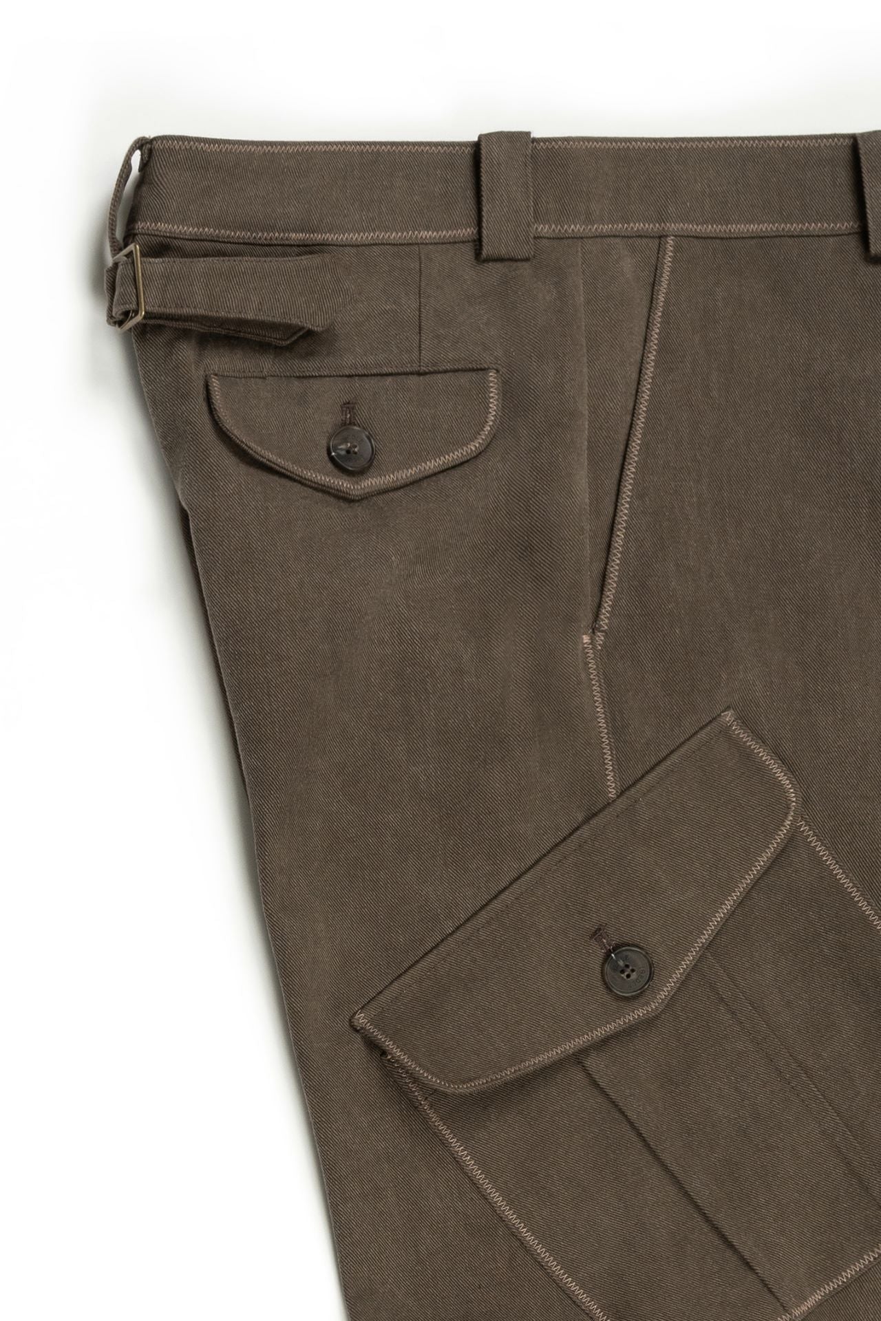Brown Dirt Cargo Pants from IOEDLE, featuring multiple pockets and rugged fabric, styled with a casual, outdoors look.