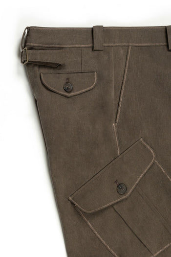 Brown Dirt Cargo Pants from IOEDLE, featuring multiple pockets and rugged fabric, styled with a casual, outdoors look.