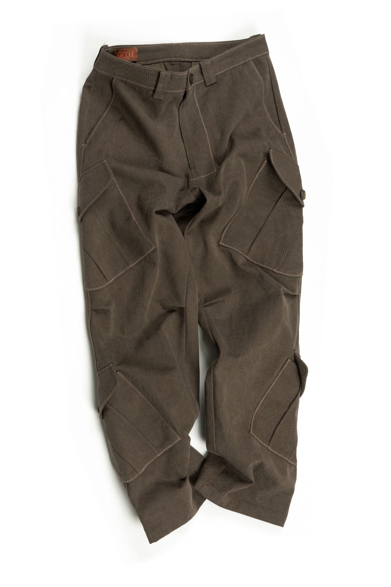 Brown Dirt Cargo Pants by IOEDLE, styled as a rugged jacket with multiple cargo pockets for outdoor wear and utility.