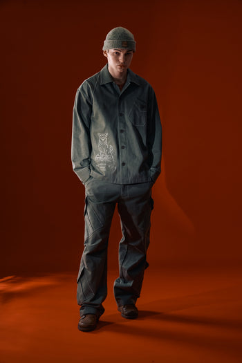 Green Dirt Cargo Pants by IOEDLE, showing durable fabric and multiple cargo pockets on a pair of casual jacket-style pants.