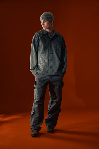 Green IOEDLE Dirt Cargo Pants worn as casual jacket style, featuring durable fabric and multiple cargo pockets.
