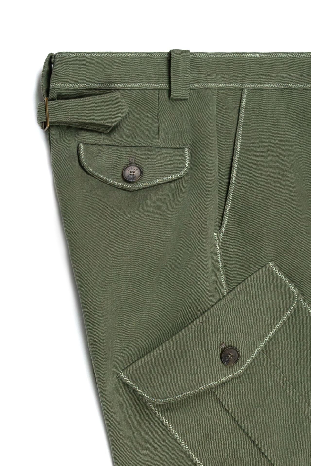 Green dirt cargo pants from IOEDLE, styled as a jacket with multiple pockets and durable fabric, suitable for outdoor wear.