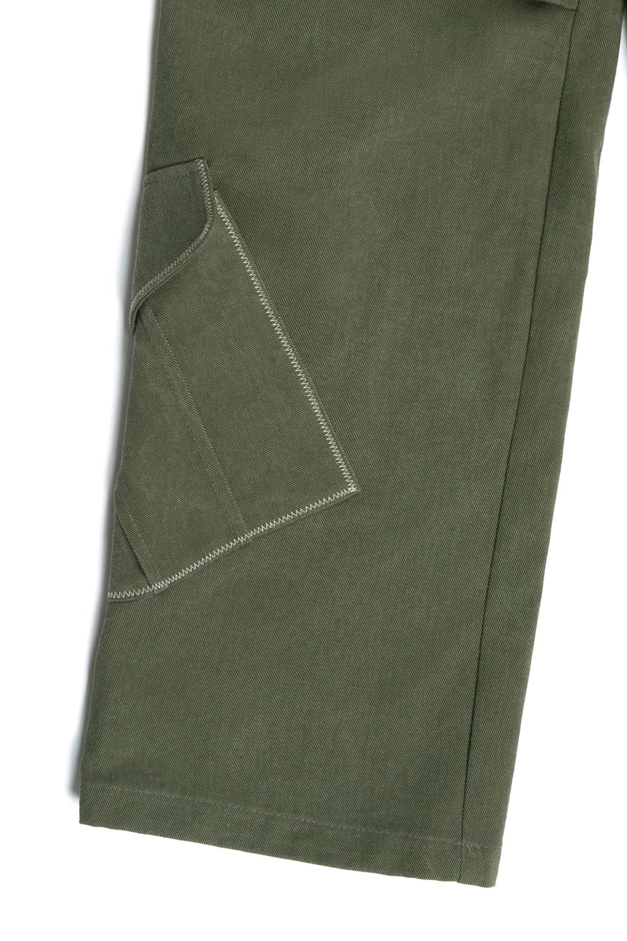 Green IOEDLE Dirt Cargo Pants worn as casual jacket, featuring multiple pockets and rugged outdoor style.