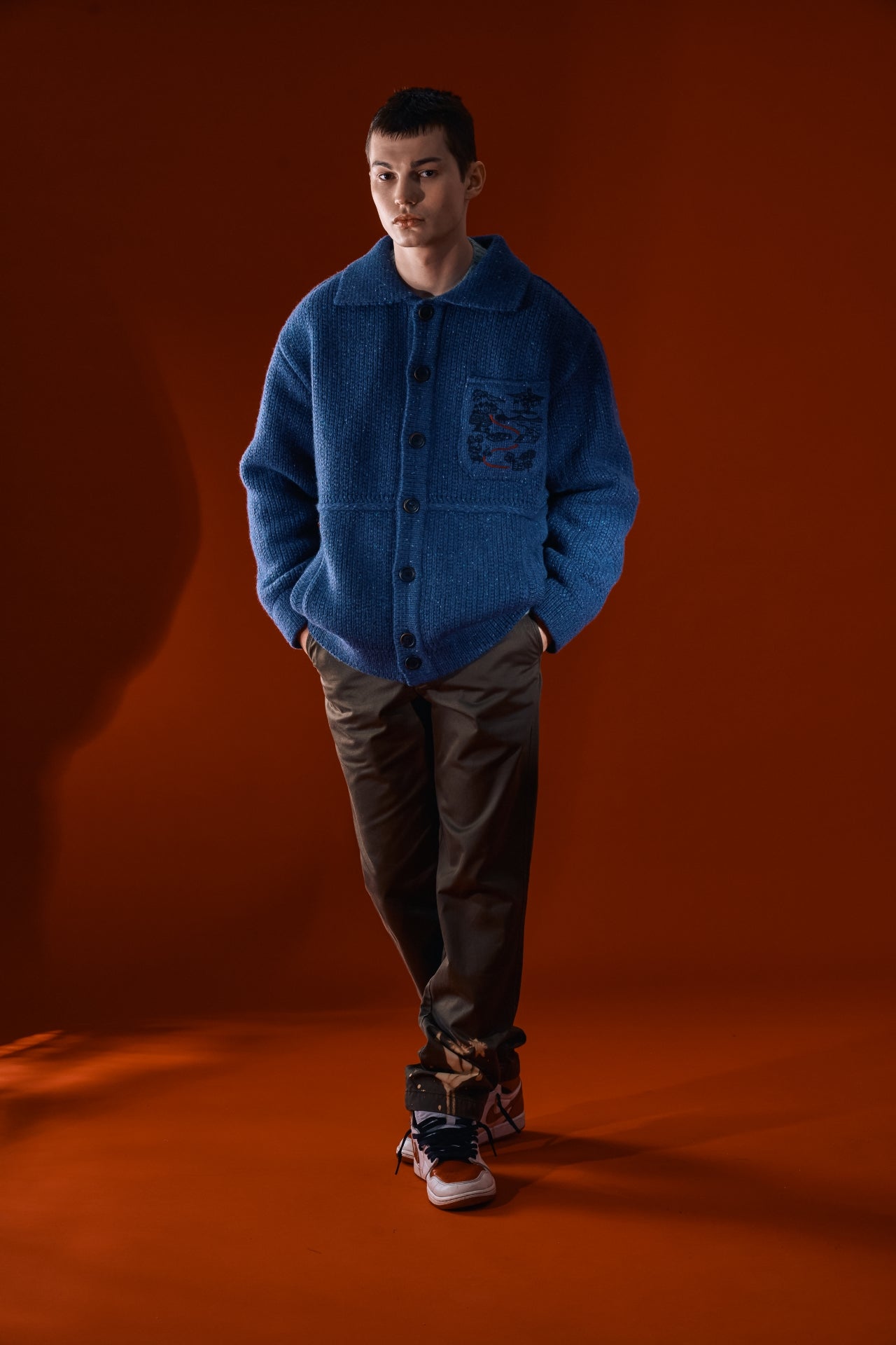 Blue IOEDLE Guide to Memories Knit Jacket with textured knit design, shown on a hanger.