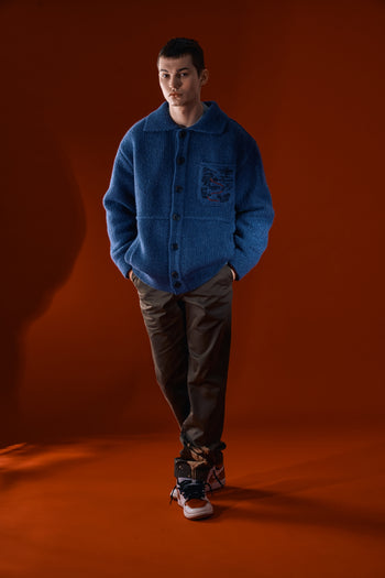 Blue IOEDLE Guide to Memories Knit Jacket with textured knit design, shown on a hanger.