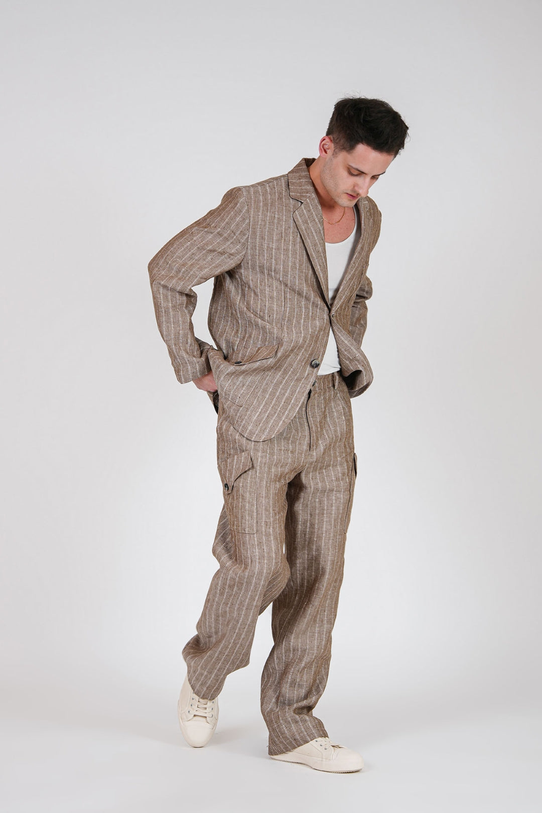 Brown linen cargo pants by IOEDLE, featuring multiple pockets and a relaxed fit, displayed on a neutral background.