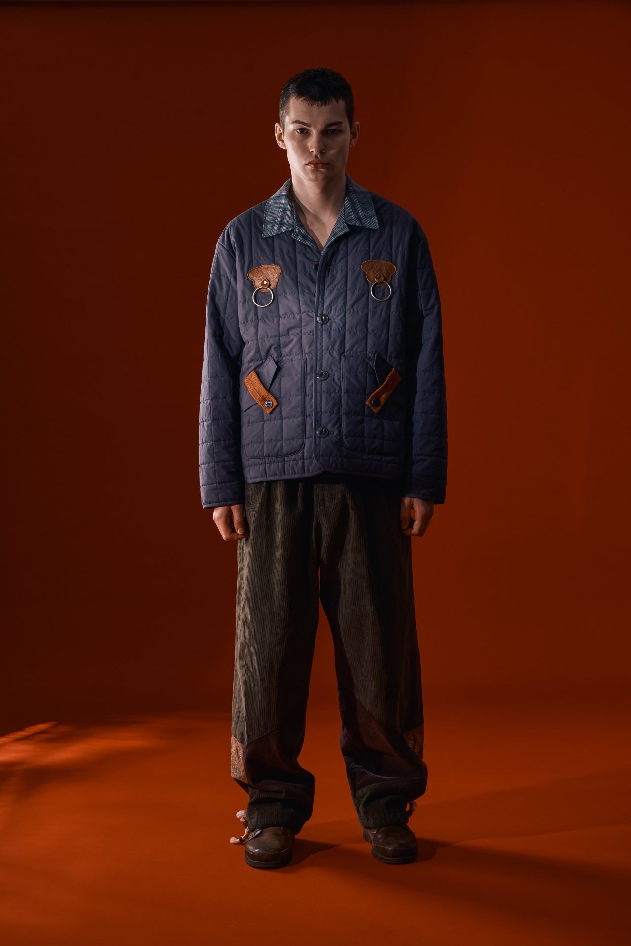 IOEDLE Welcoming Gate Quilted Jacket in charcoal, cozy and stylish, shown on a hanger with a quilted pattern and padded design.
