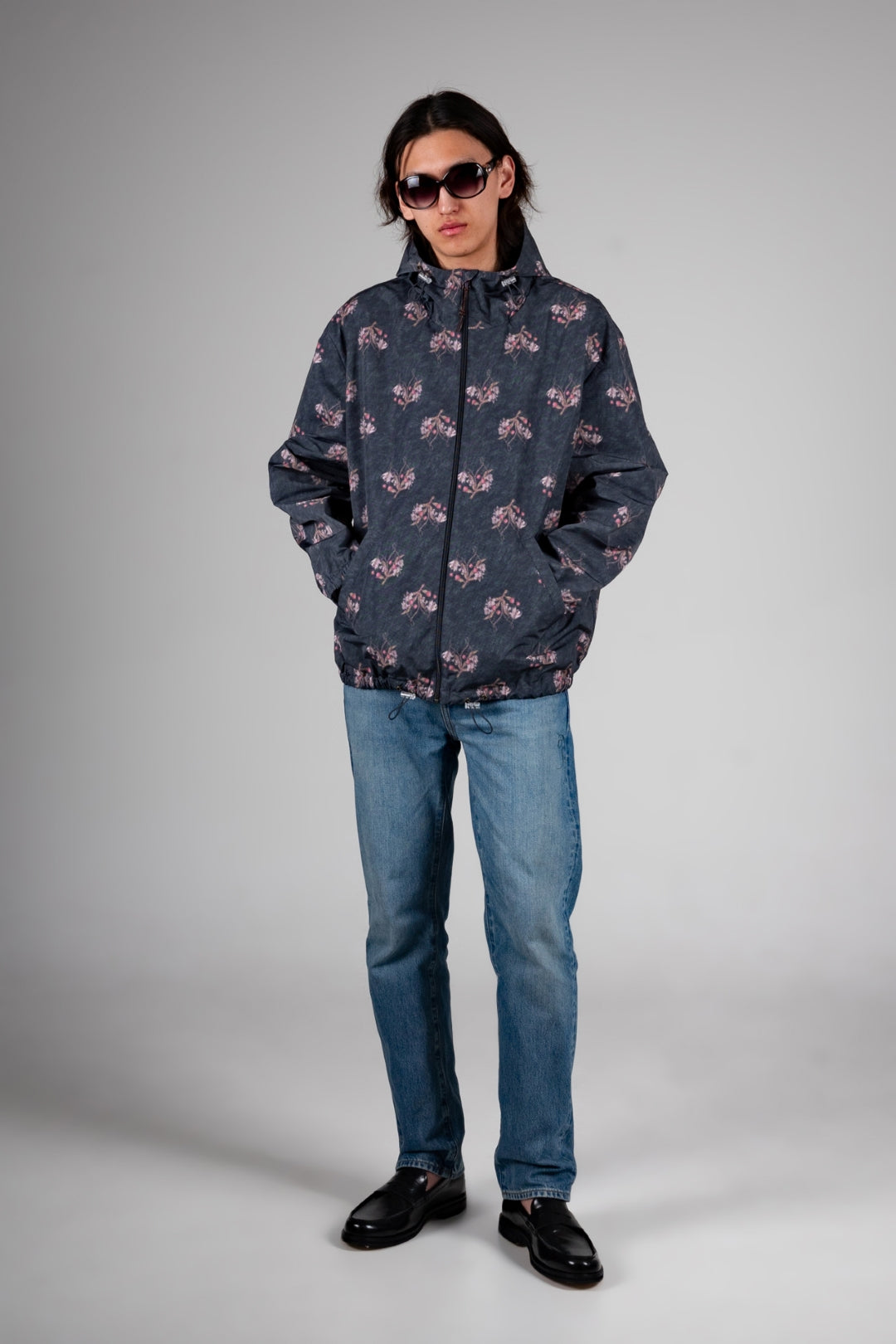Dark grey IOEDLE windbreaker jacket featuring a colorful flower graphic design, lightweight and stylish for outdoor wear.