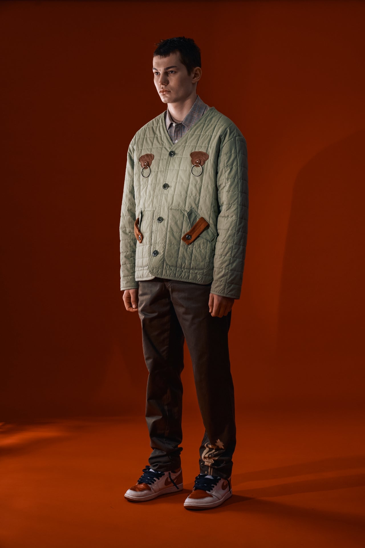 Olive green IOEDLE Welcoming Gate Quilted Jacket with a cozy, padded design and front zipper, displayed on a model.
