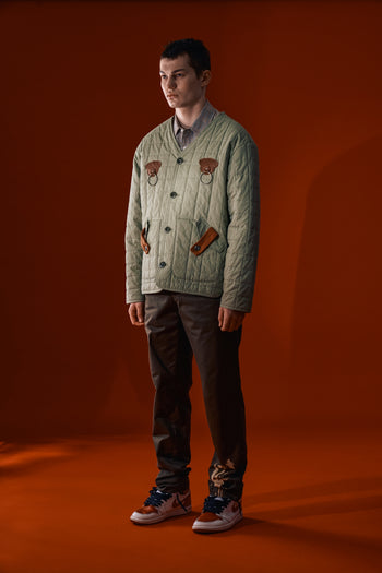 Olive green IOEDLE Welcoming Gate Quilted Jacket with a cozy, padded design and front zipper, displayed on a model.