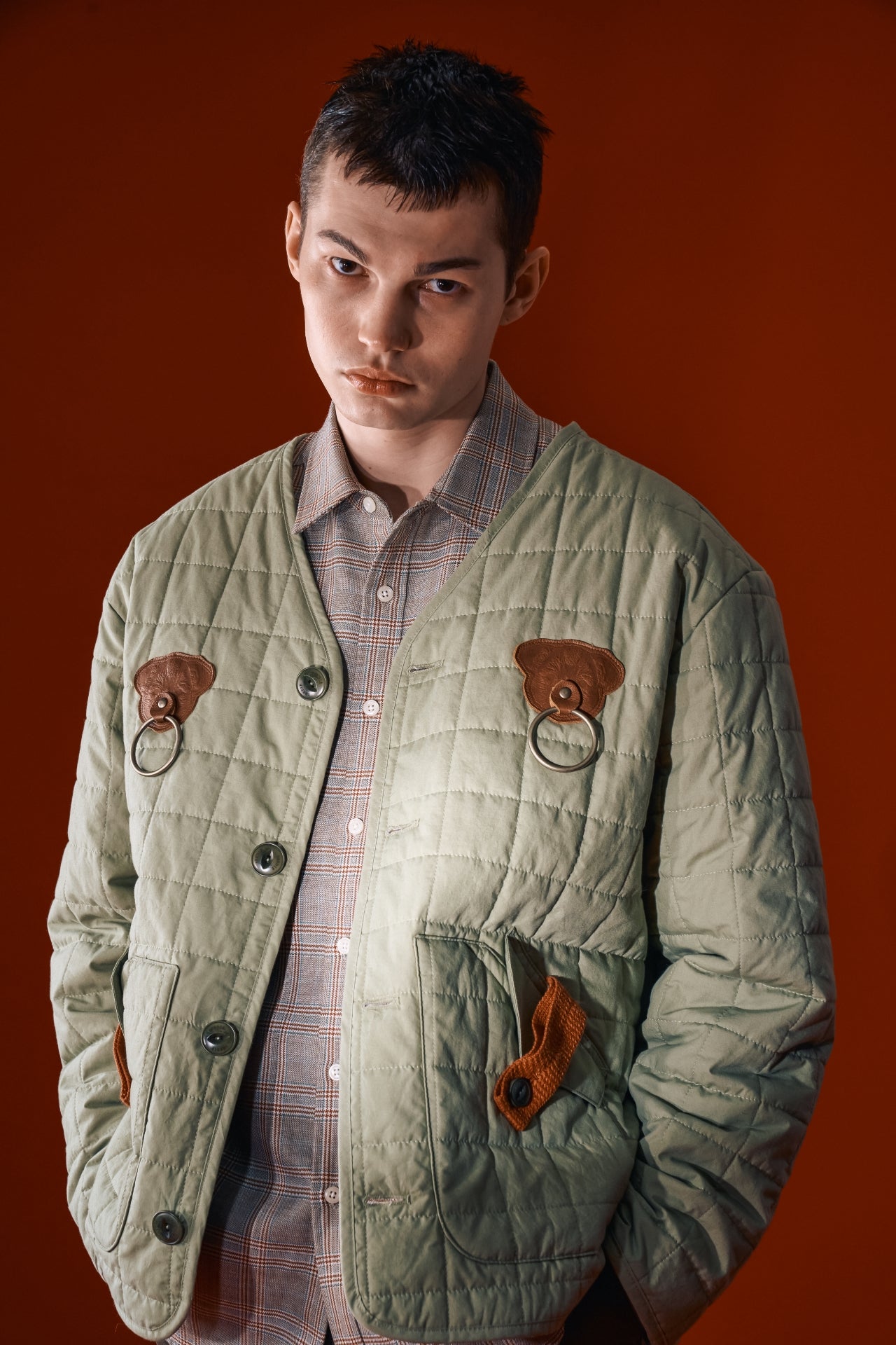 Olive green quilted jacket from IOEDLE featuring a welcoming gate design, padded for warmth and casual wear.