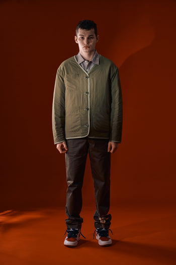 Olive quilted jacket from IOEDLE's Welcoming Gate collection, featuring a cozy, stylish design with a front zipper and padded texture.