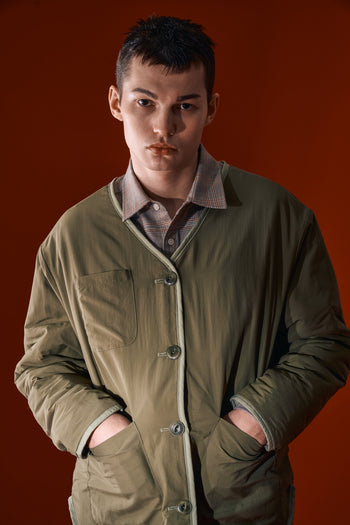 IOEDLE Welcoming Gate Quilted Jacket in olive color, stylish and warm, shown on a model with a front view.