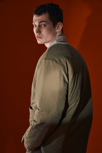 Olive green quilted jacket by IOEDLE featuring a welcoming gate design, padded for warmth and stylish comfort.
