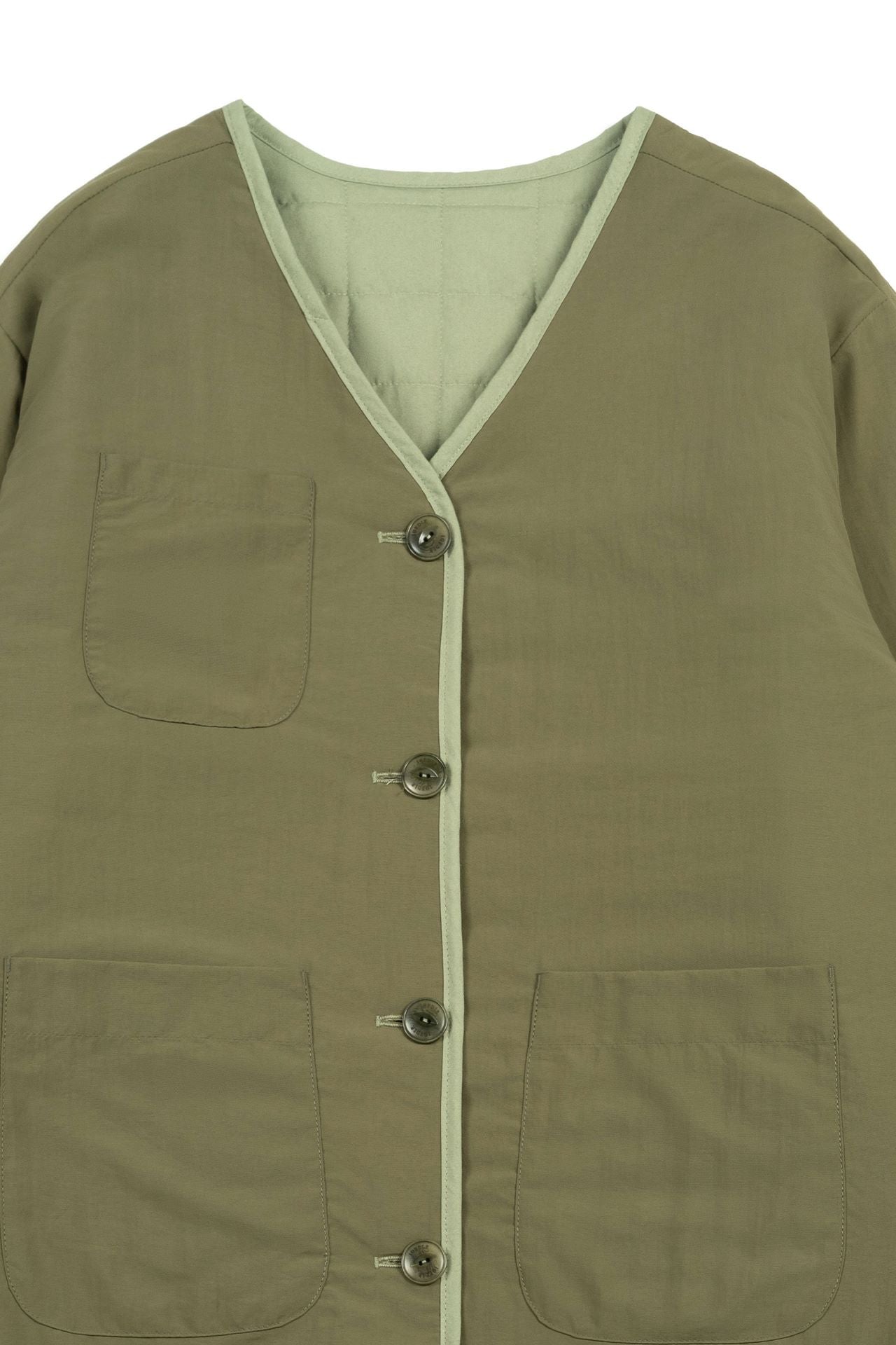 Olive green quilted jacket by IOEDLE, featuring a welcoming gate design, shown on a model in a casual outdoor setting.