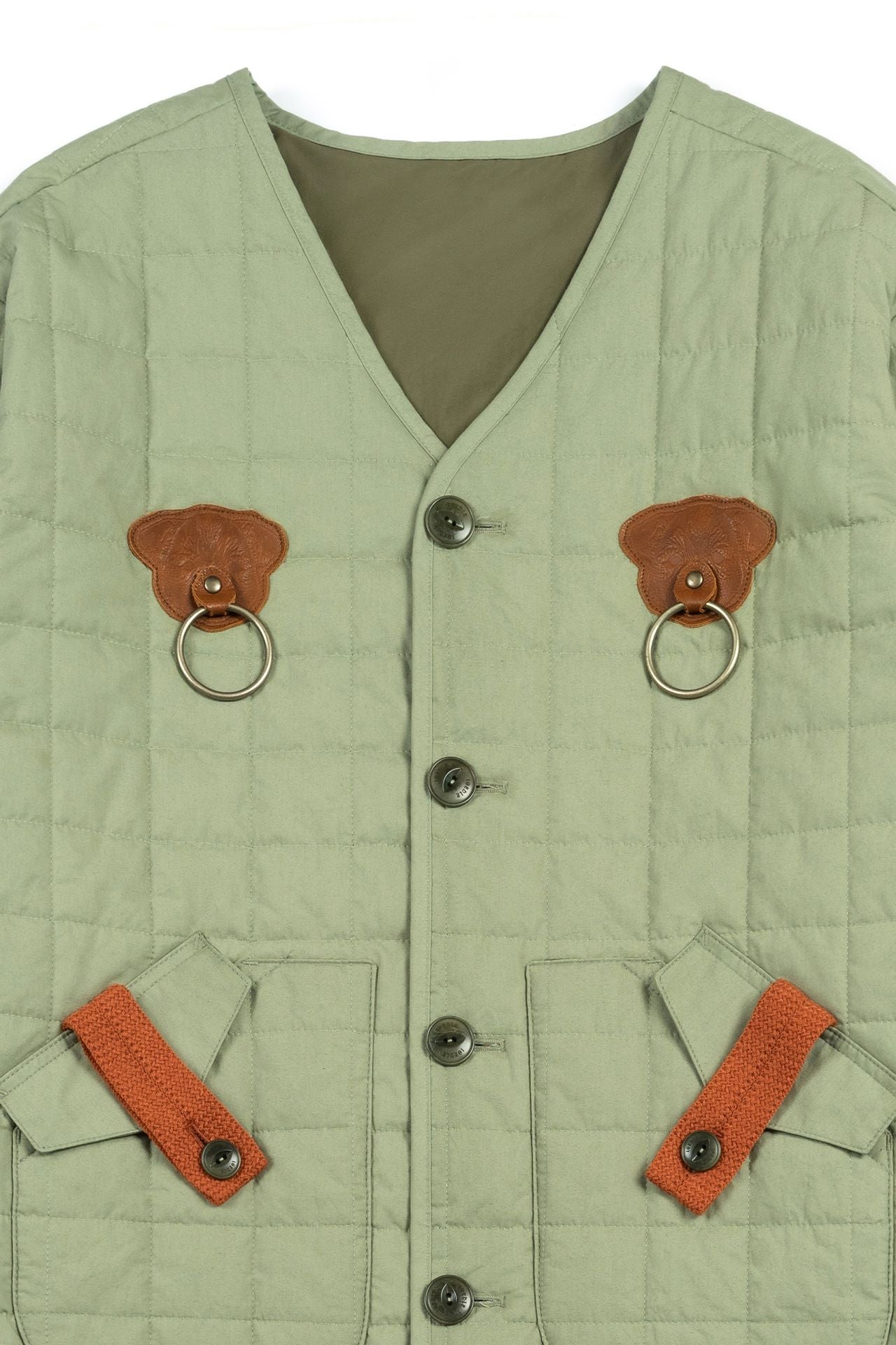 Olive quilted jacket by IOEDLE, featuring a welcoming gate design, shown on a model in a casual outdoor setting.