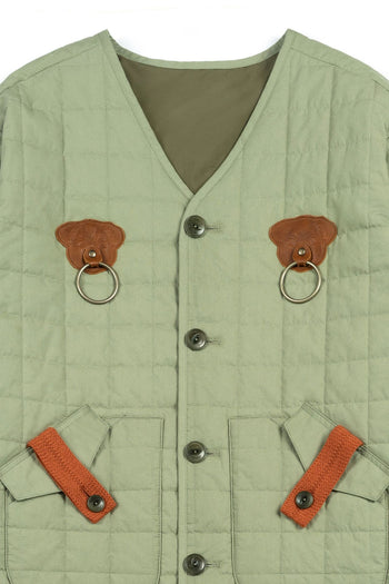 Olive quilted jacket by IOEDLE, featuring a welcoming gate design, shown on a model in a casual outdoor setting.