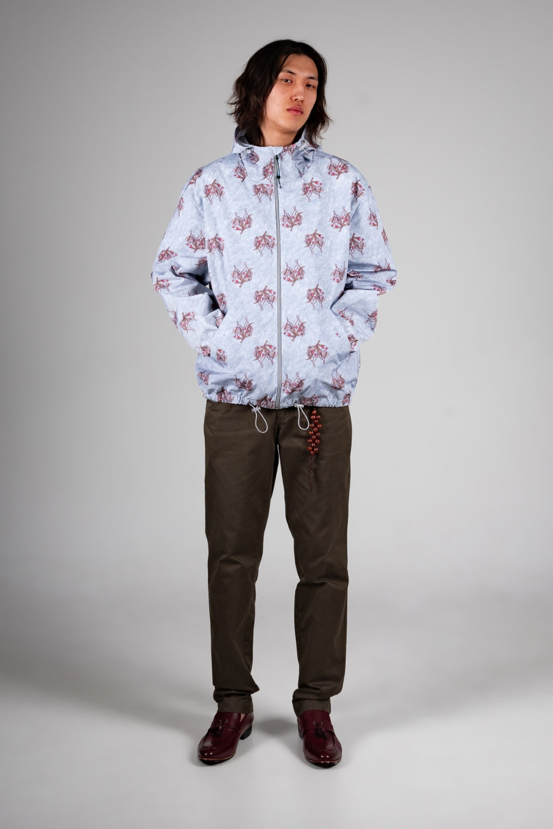Sky blue IOEDLE flower graphic windbreaker jacket with long sleeves and lightweight design, perfect for outdoor wear.