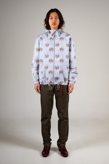 Sky blue IOEDLE flower graphic windbreaker jacket, lightweight and stylish, shown with vibrant floral design on the front.