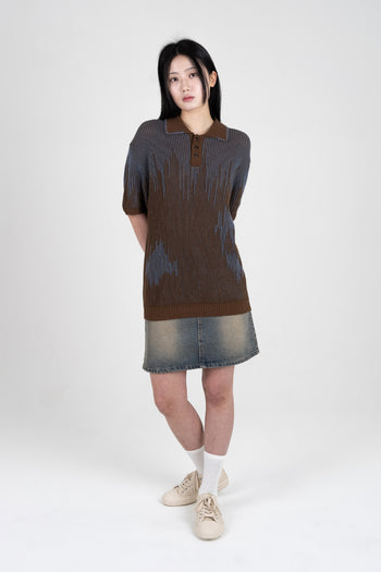 Brown Meteor Shower Knit shirt by IOEDLE displayed on a hanger, showcasing its textured fabric and casual style.