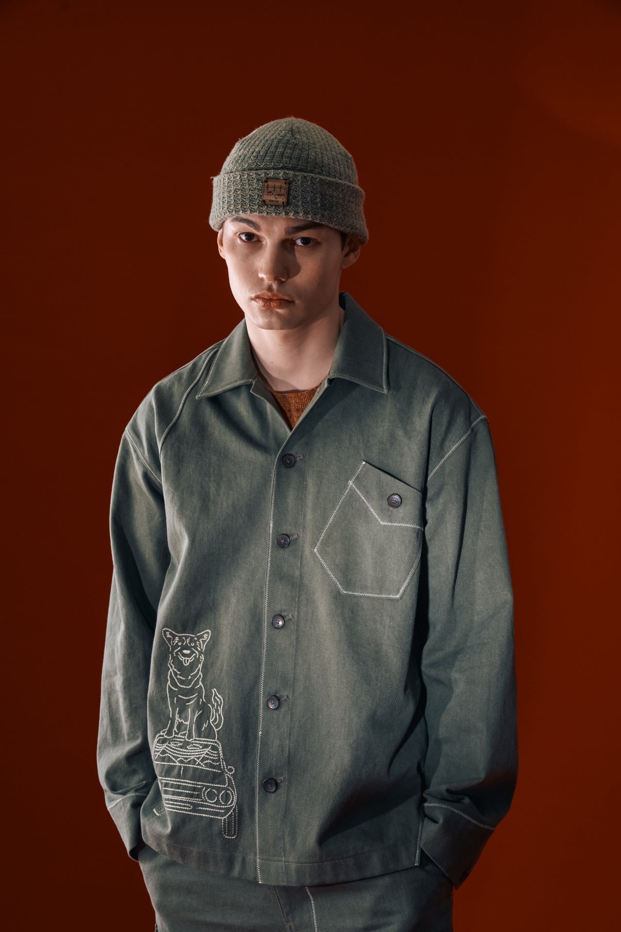 Green diagonal landscape shirt by IOEDLE, featuring a stylish geometric pattern, shown on a hanger.