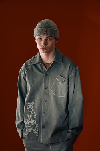 Green diagonal landscape shirt by IOEDLE, featuring a stylish geometric pattern, shown on a hanger.