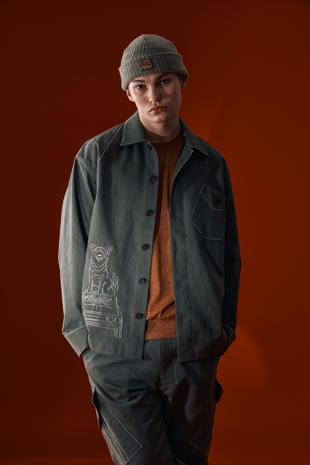 Green diagonal landscape shirt by IOEDLE, featuring a stylish geometric pattern, shown on a hanger with a close-up view.