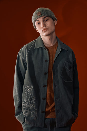 Green IOEDLE diagonal landscape shirt displayed flat with collar and sleeves, showcasing the stylish design and fabric texture.