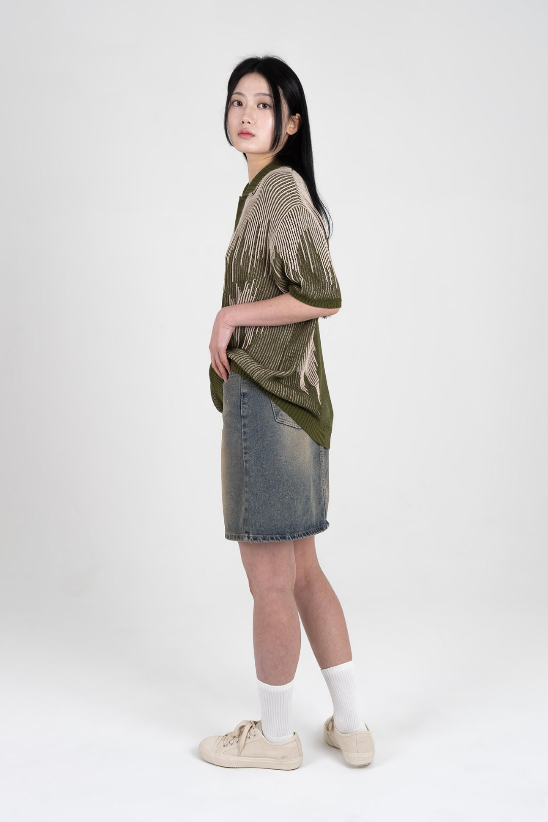 IOEDLE Meteor Shower Knit Khaki shirt with long sleeves and ribbed collar, displayed on a hanger.
