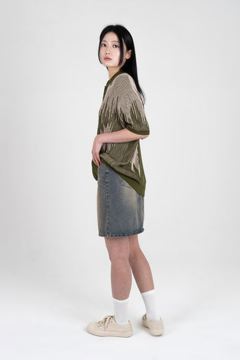 IOEDLE Meteor Shower Knit Khaki shirt with long sleeves and ribbed collar, displayed on a hanger.