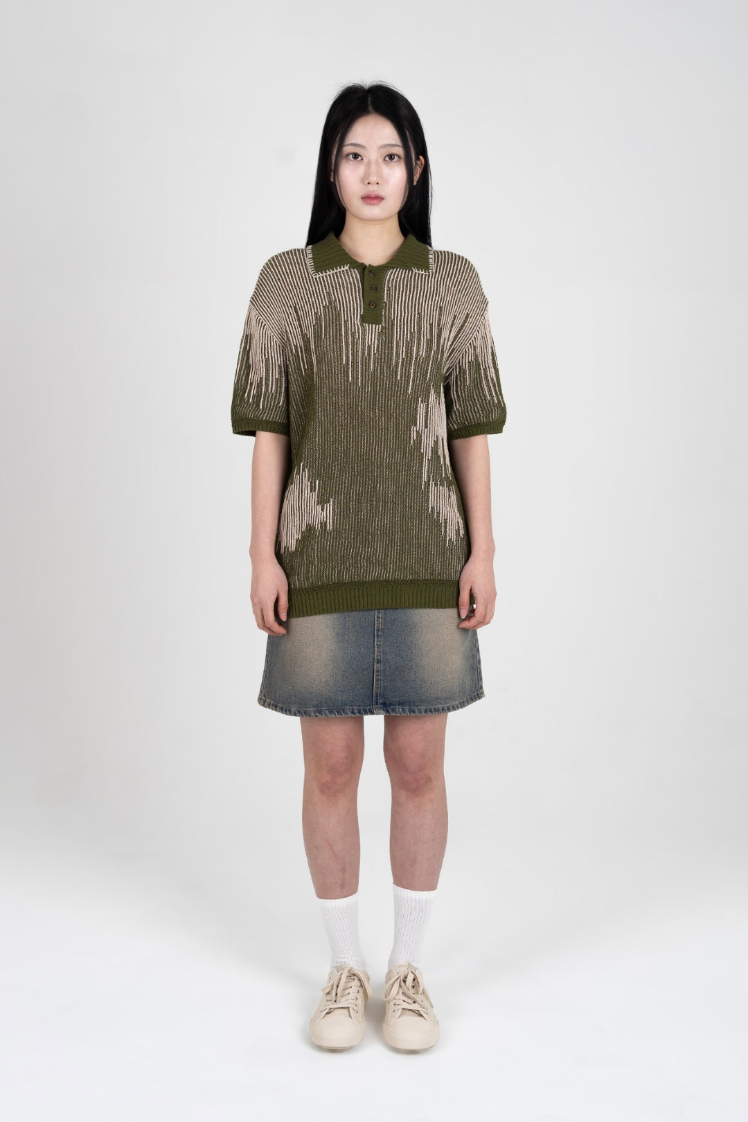 IOEDLE Meteor Shower Knit Khaki shirt displayed on a hanger, showcasing the casual, textured knit fabric and relaxed fit.