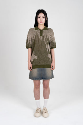 IOEDLE Meteor Shower Knit Khaki shirt displayed on a hanger, showcasing the casual, textured knit fabric and relaxed fit.