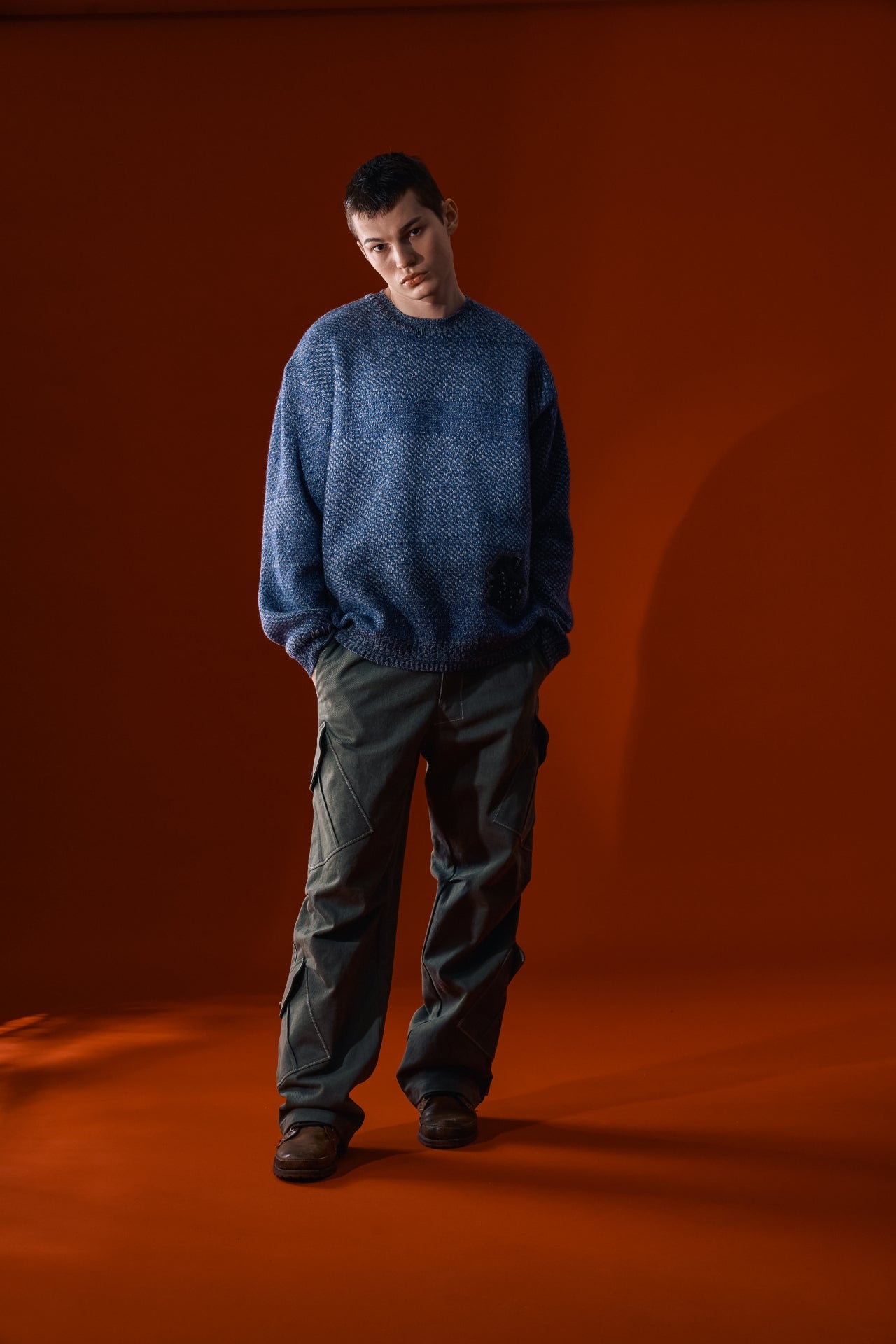Navy House of Cars sweater by IOEDLE, featuring a cozy knit design, displayed on a hanger against a neutral background.