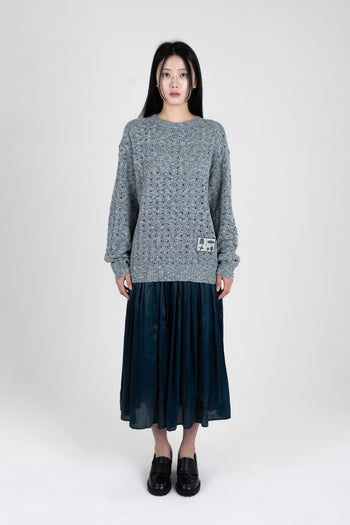 Blue IOEDLE Beyond The Glass Mesh Knit sweatshirt with a relaxed fit, showcasing its textured knit fabric and casual style.