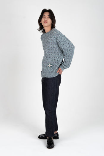 Blue mesh knit sweatshirt by IOEDLE with "Beyond The Glass" design, featuring a comfortable fit and stylish casual look.