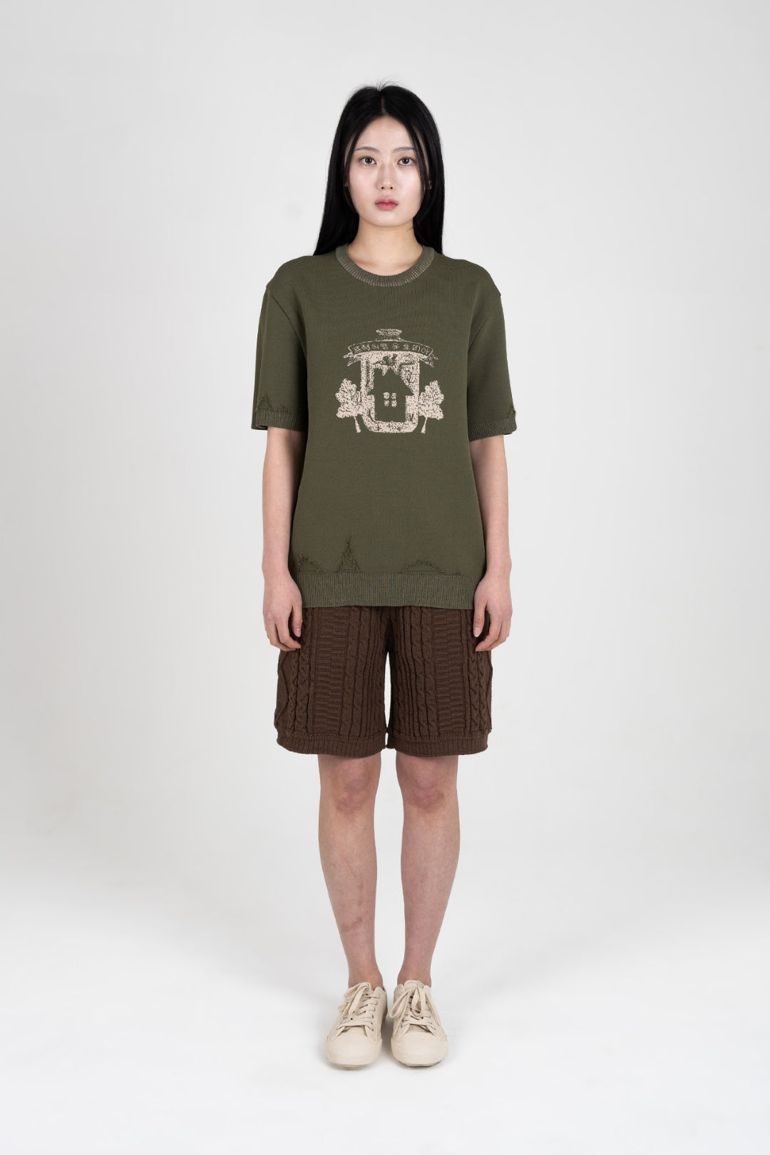 IOEDLE Practical Utopia knitted top in khaki, showing a close-up of the textured fabric and stylish fit.