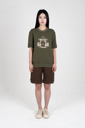 IOEDLE Practical Utopia knitted top in khaki, showing a close-up of the textured fabric and stylish fit.