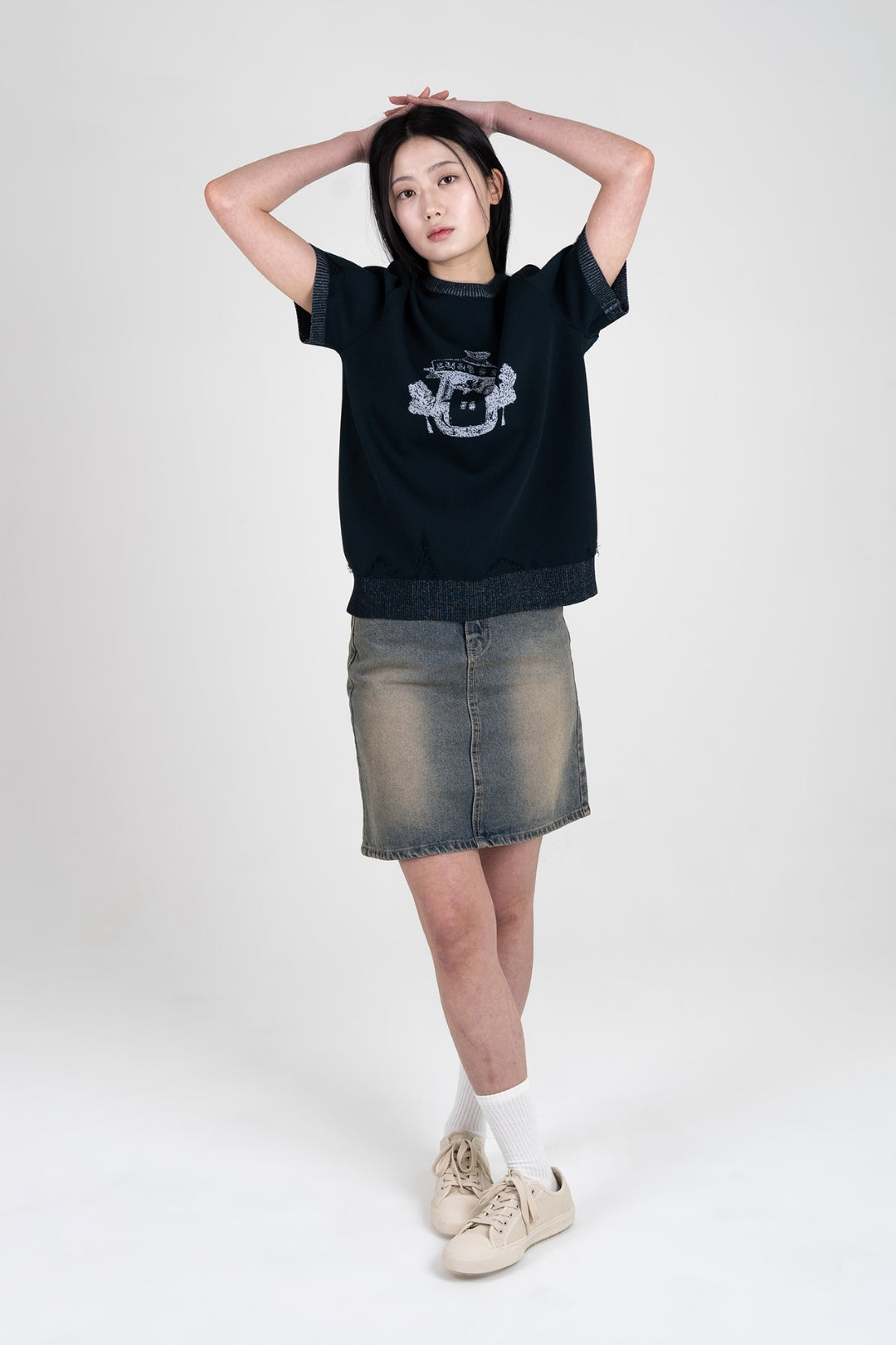 Navy knitted top from IOEDLE's Practical Utopia collection, featuring a cozy, fitted design ideal for casual wear.
