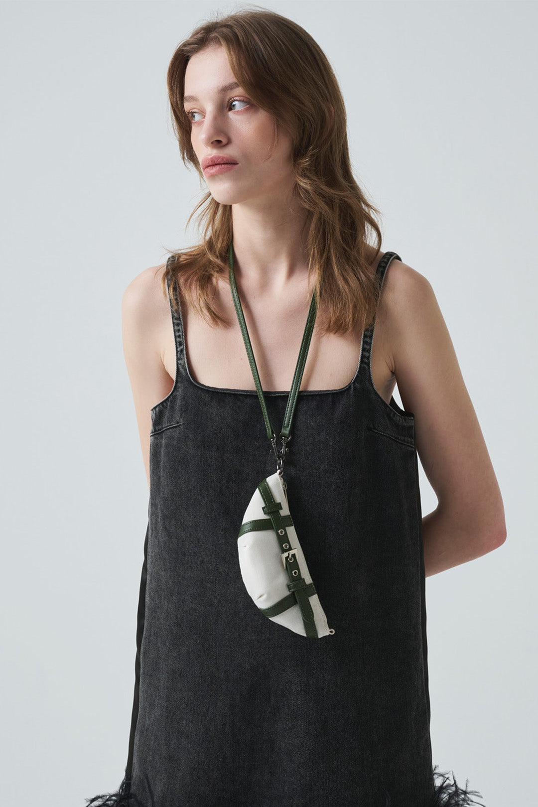 LE SAUT GOCHI Mini Bag featuring a compact, stylish design with a top handle and adjustable strap, perfect for everyday use.